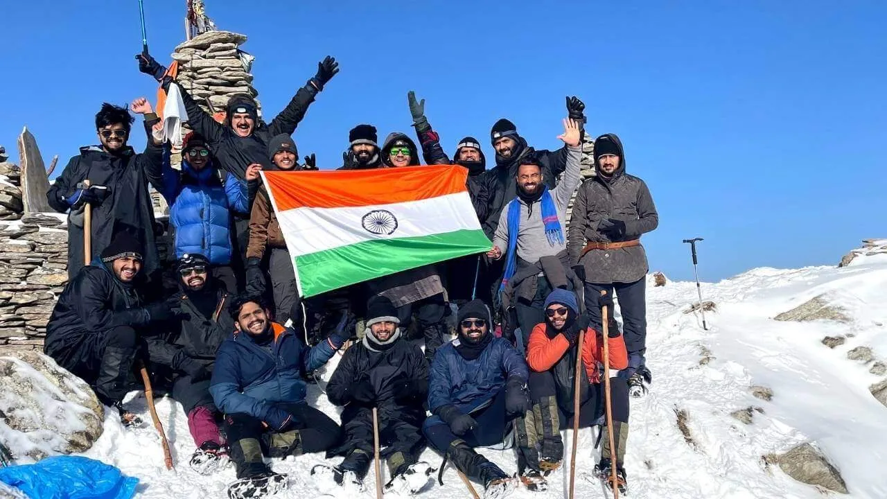 The flag at a snow-covered summit on a winter trek