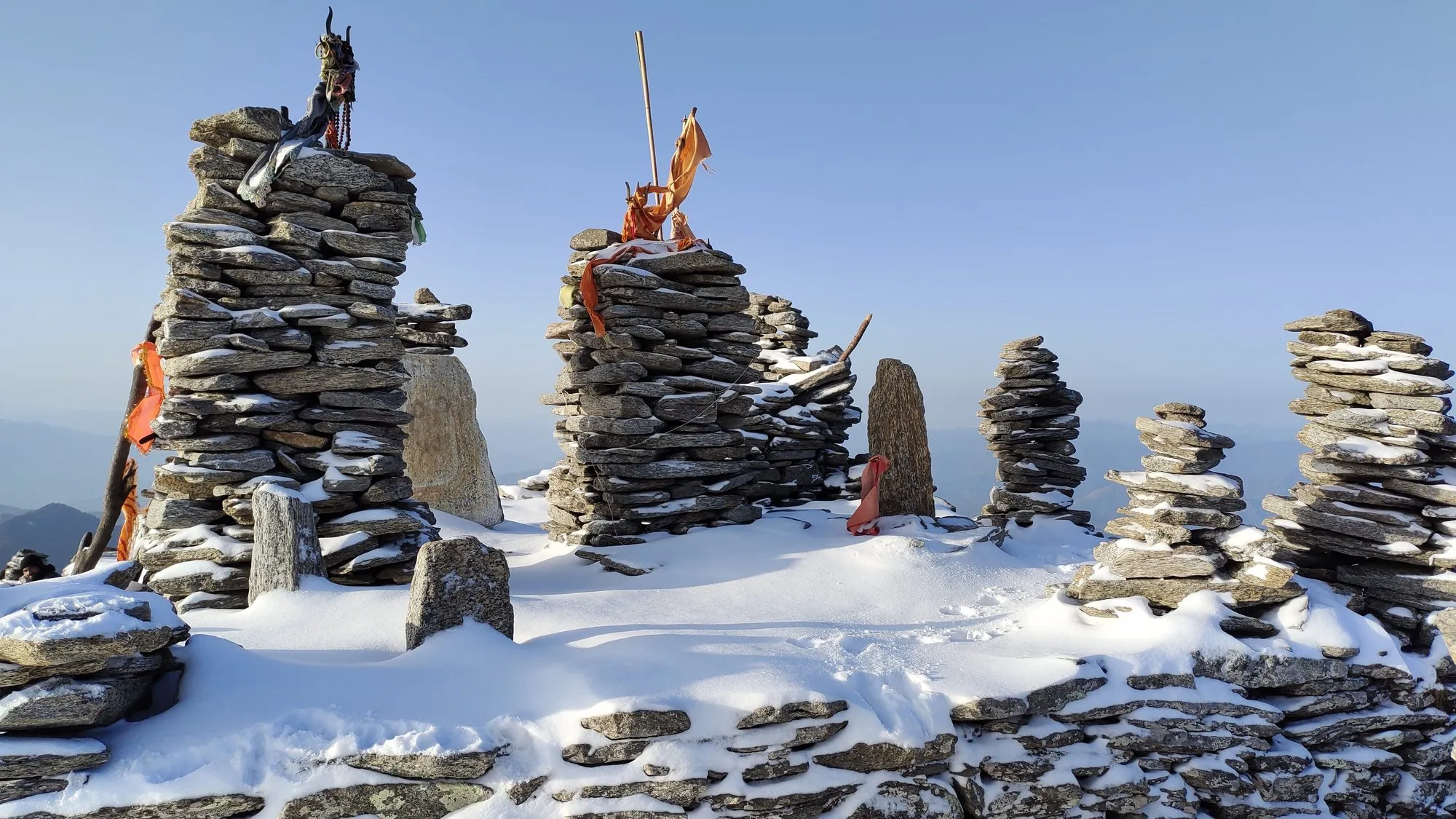 Stone cairns on the Kedarkantha summit
