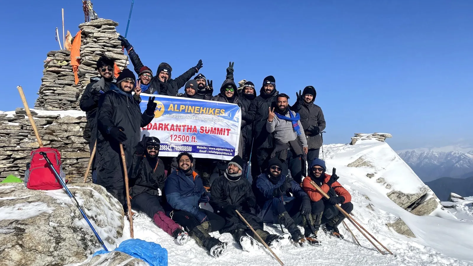 The Alpine Hikes banner on Kedarkantha summit