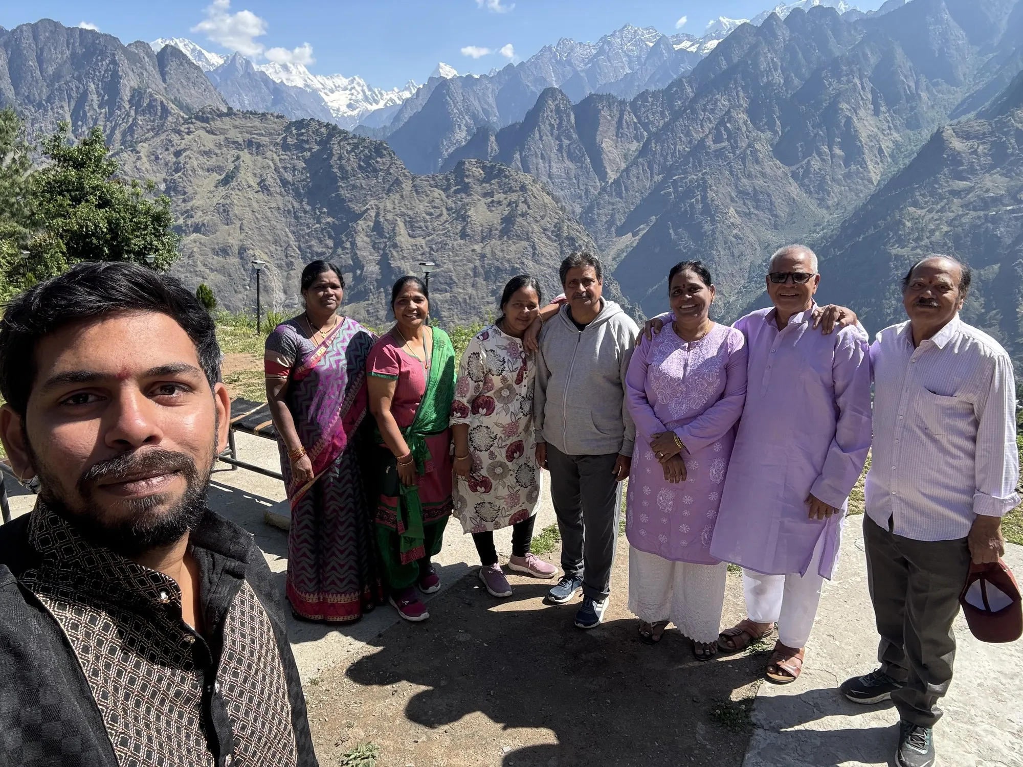 A yatra group with the snow peaks behind them