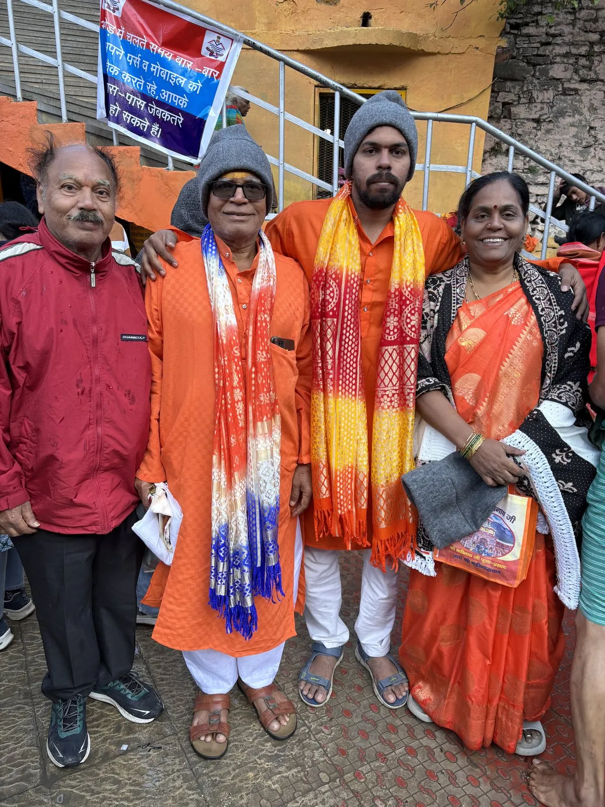 Yatris in darshan shawls with the Alpine Hikes banner