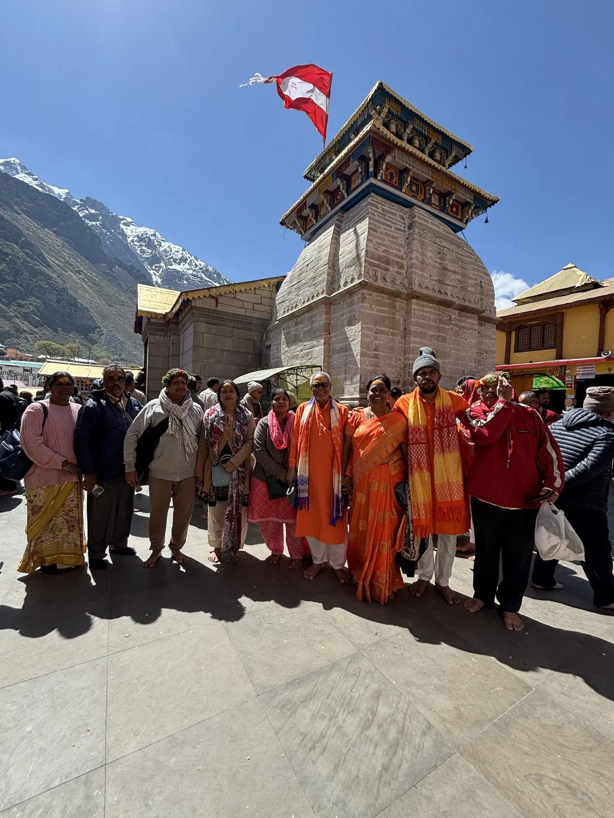 Our group at a mountain shrine, snow peaks behind